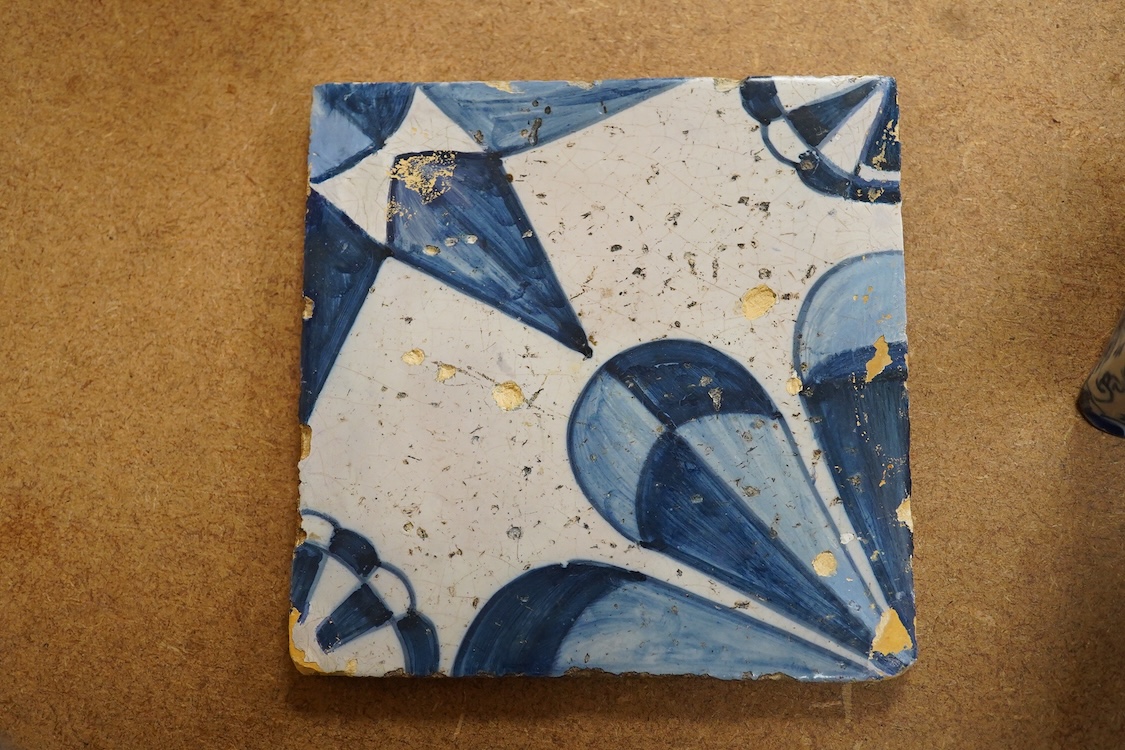 An 18th century Delft tea caddy decorated with figures and flowers and tile, 13cm square